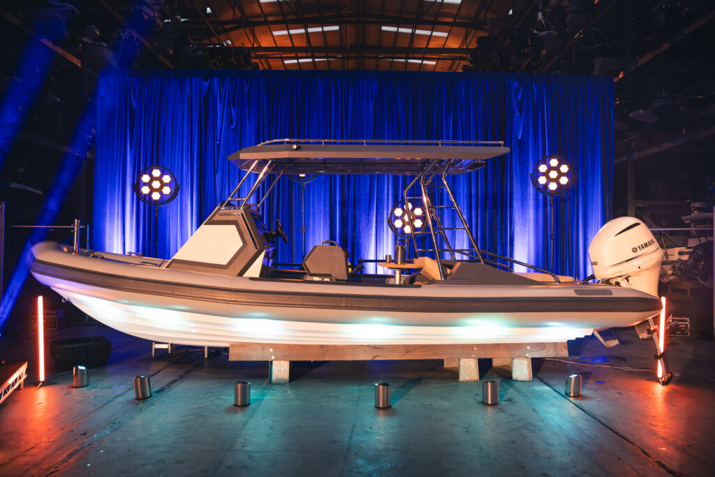 Product reveal on a lit stage at a launch event